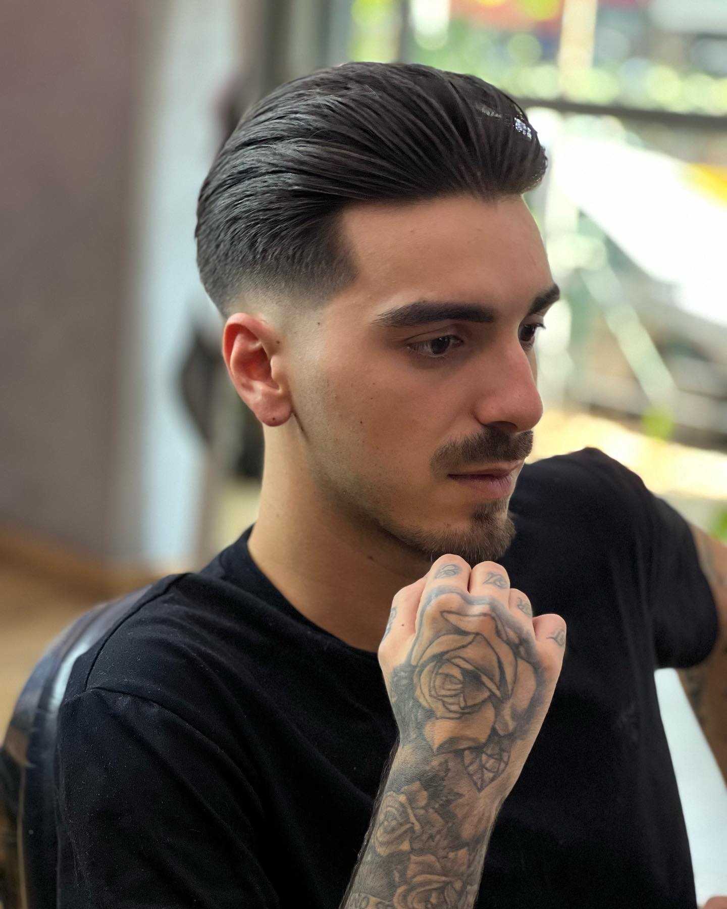 Men's slick styled top with a skin fade at BarberShop Amarildo, Tirana
