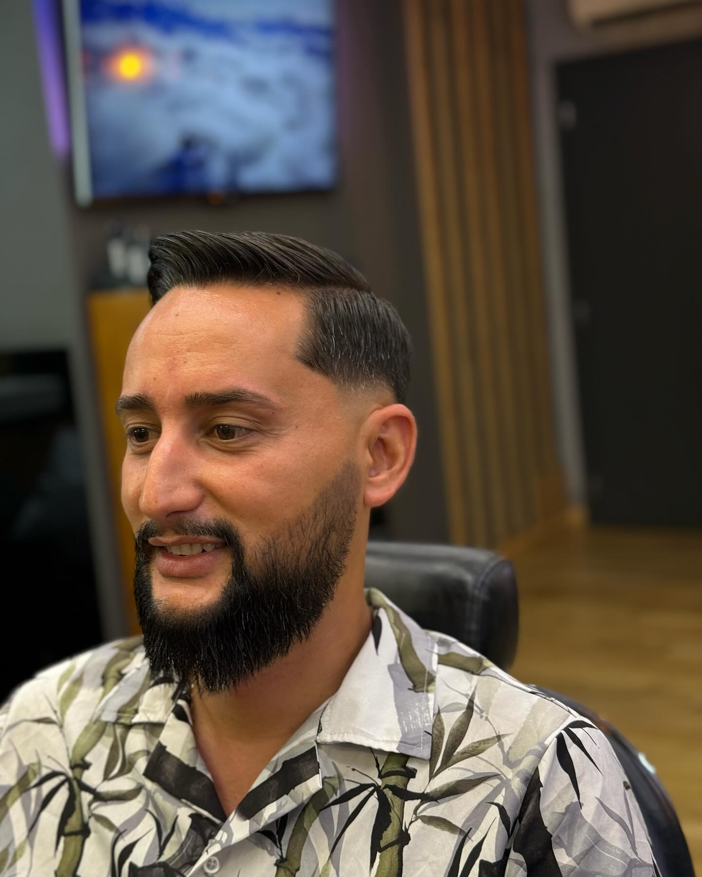 Classic side part with a shaped beard