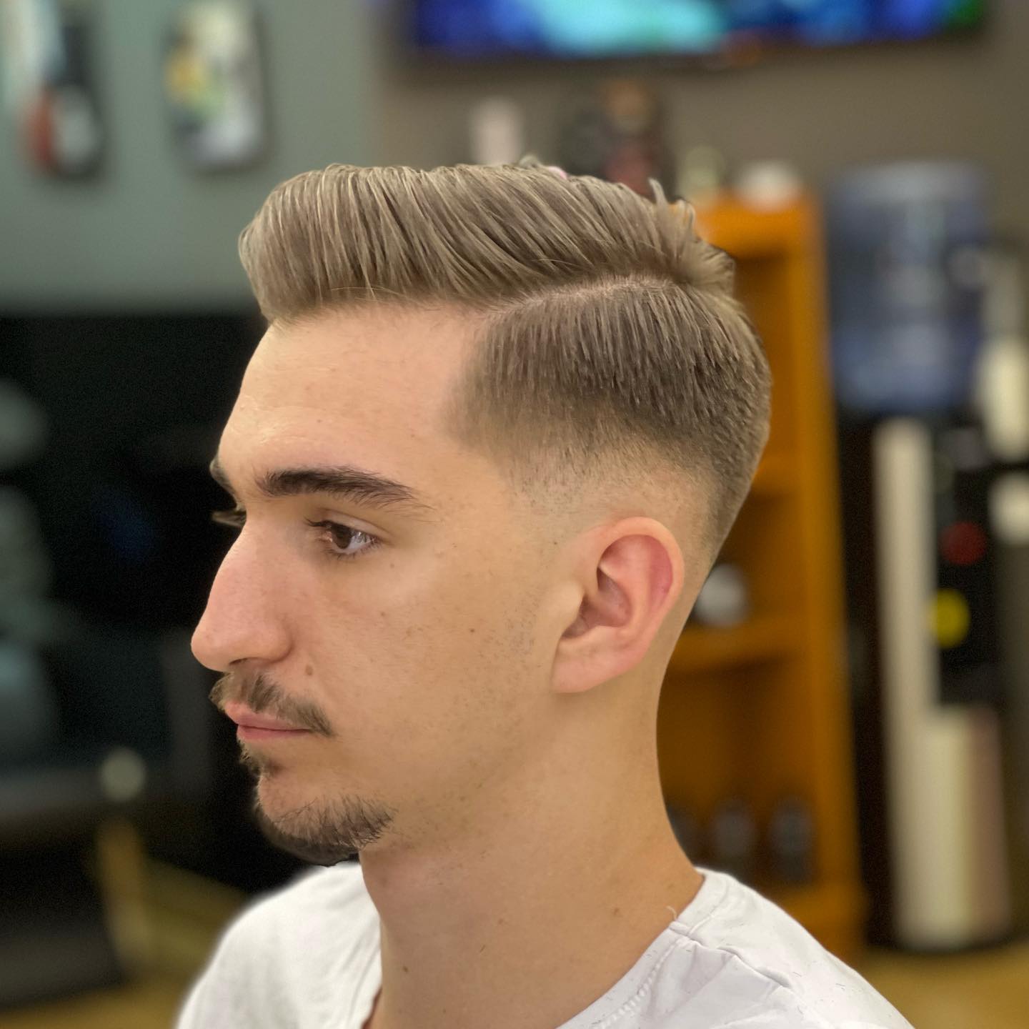 Clean side part with a skin fade
