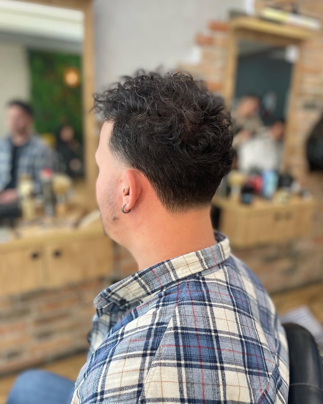 Curly textured top with a back fade